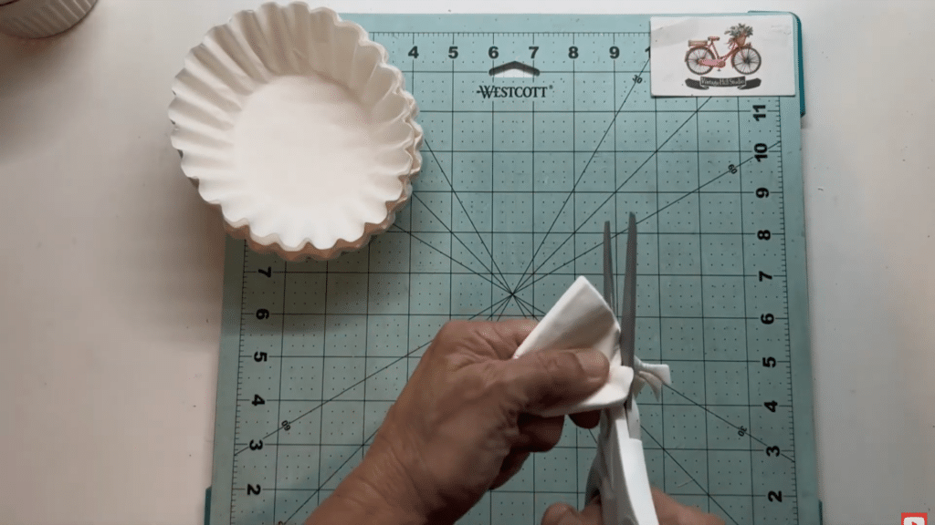 cutting folded coffee filters to create petal shapes