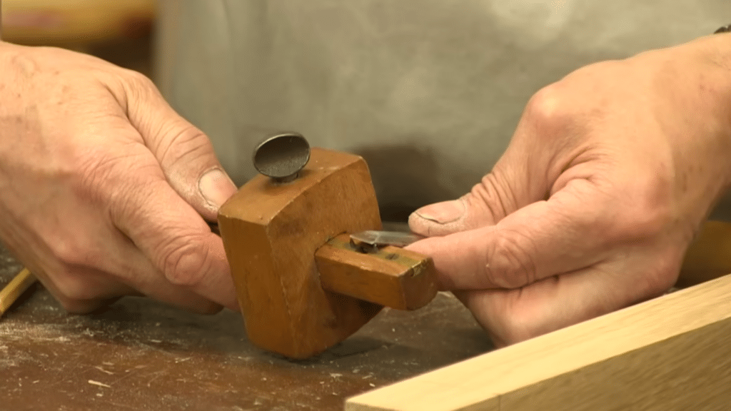 cutting the mortise and tenon to size for a precise and secure fit in woodworking