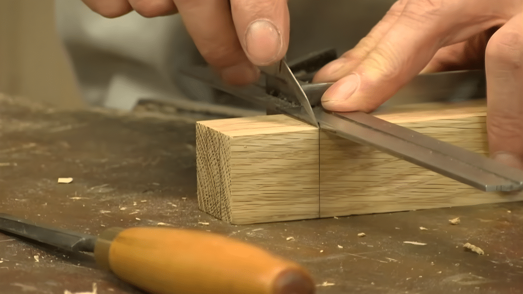 cutting the tenon to size for a precise fit into the mortise joint