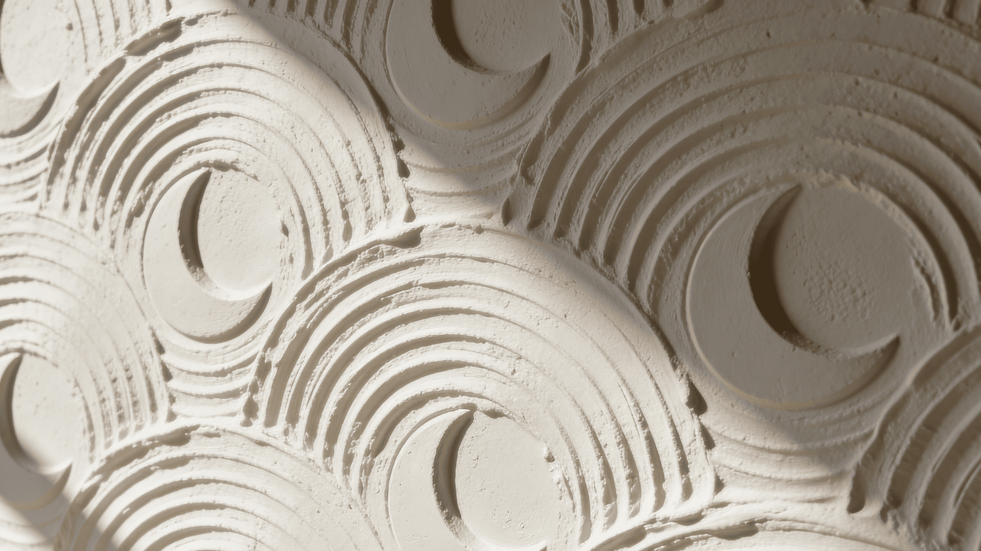 decorative wall with curved textured plaster patterns in soft light