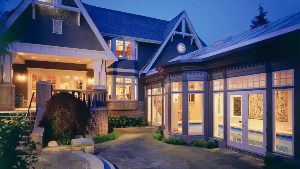 Designing a Property That Makes a Lasting First Impression Elegant house exterior at dusk with warm lighting and landscaped patio walkway