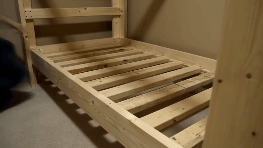 diy bunk beds frame with wooden slats installed showing sturdy base structure during indoor build process