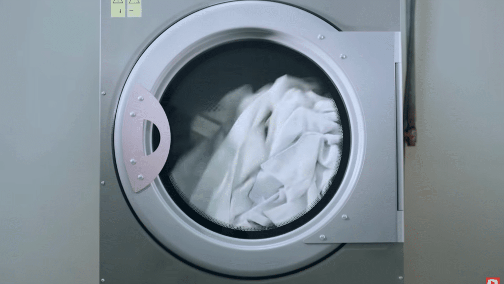 drying blanket on low heat inside dryer machine