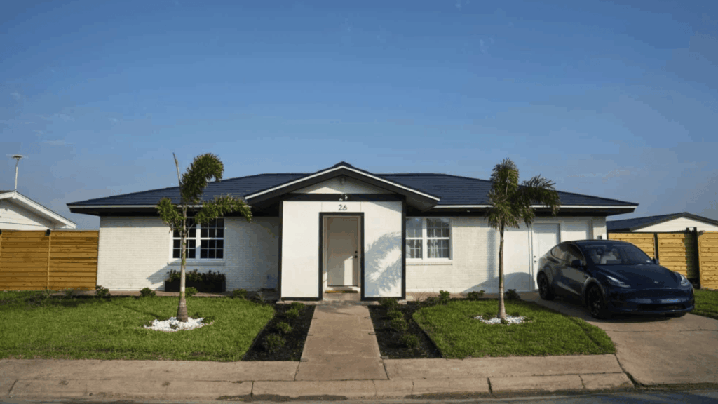 elon musk's boca chica home is a simple prefabricated house with a tesla parked in front and a well-maintained yard