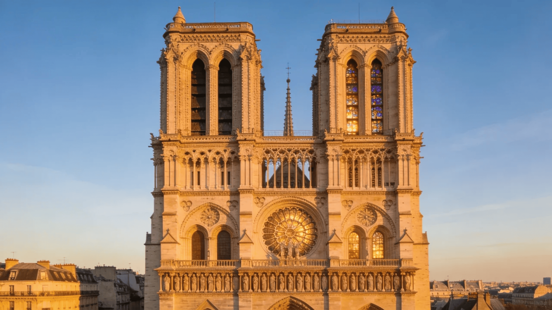 european architecture gothic cathedral facade with twin towers and stained glass glowing in sunlight