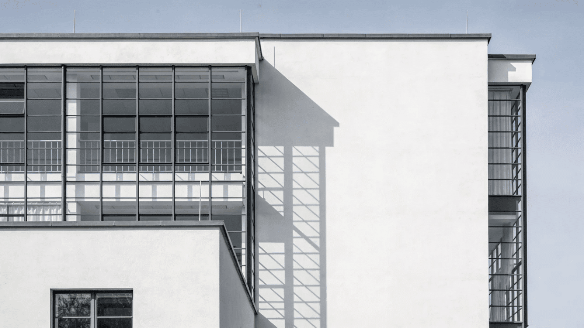 european architecture modern minimalist building with glass facade and geometric shadows