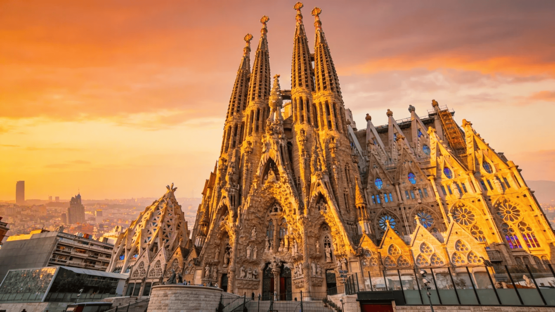 european architecture ornate basilica with tall spires and intricate facade glowing at sunset
