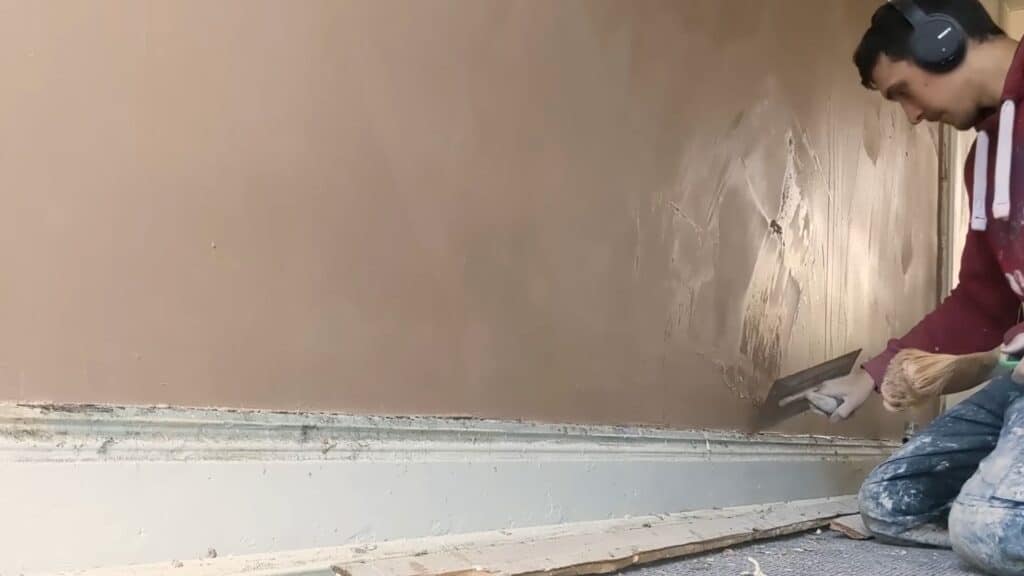 final polishing of plaster wall with trowel creating smooth finish and subtle shine before drying