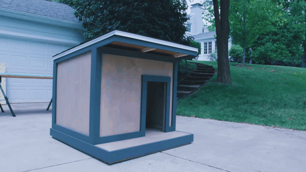finished dog house with painted trim and entrance opening