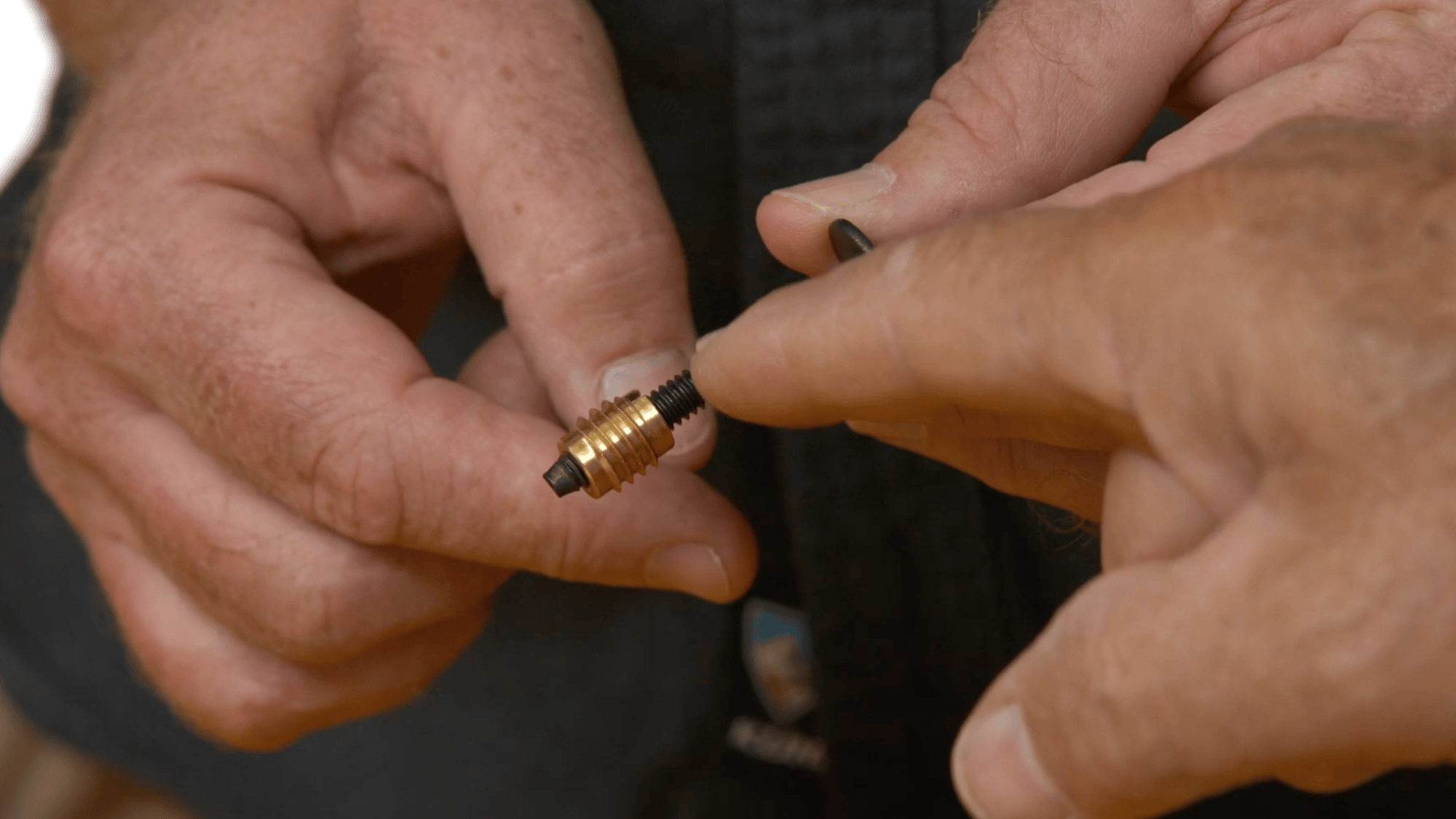 hands holding threaded insert and bolt for diy clothes rack assembly showing how parts connect securely