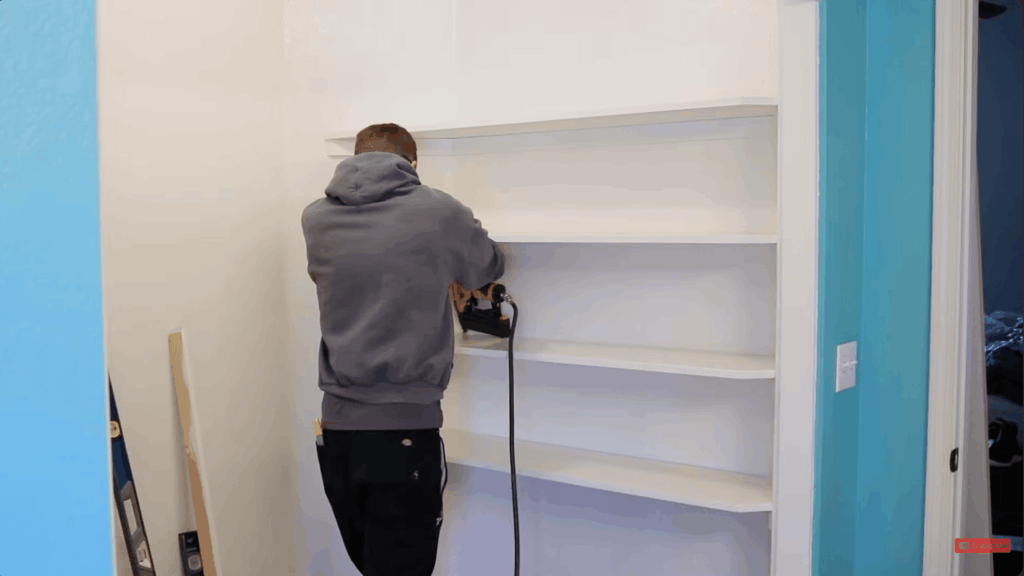 installing mdf shelves on supports and securing them using a level for proper alignment