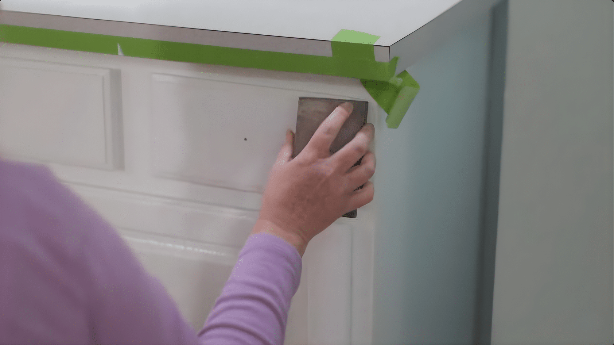 light sanding after priming while painting bathroom cabinets to smooth surface and remove brush marks