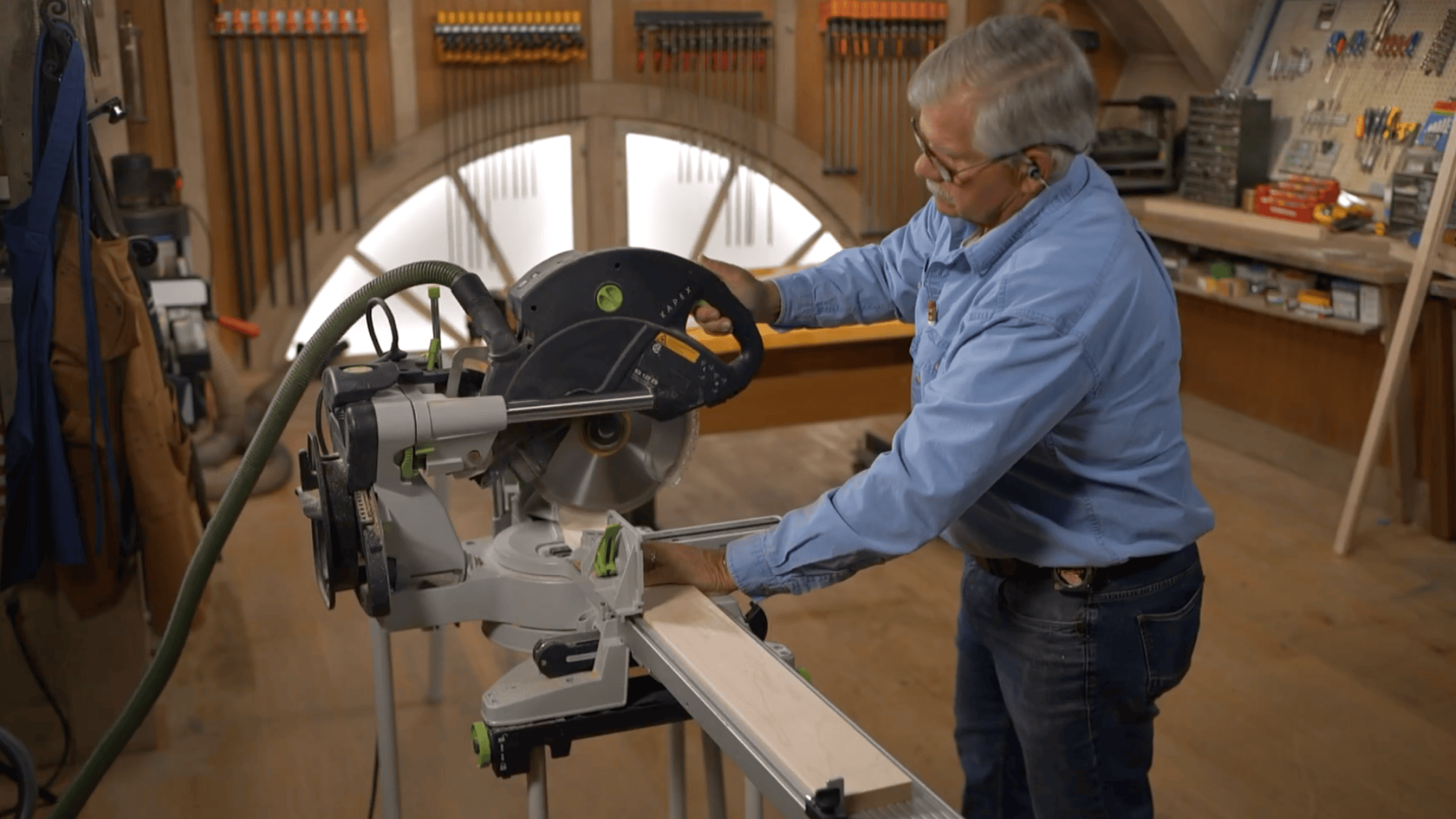 man cutting wood pieces with saw after making cut list for diy clothes rack build and accurate sizing