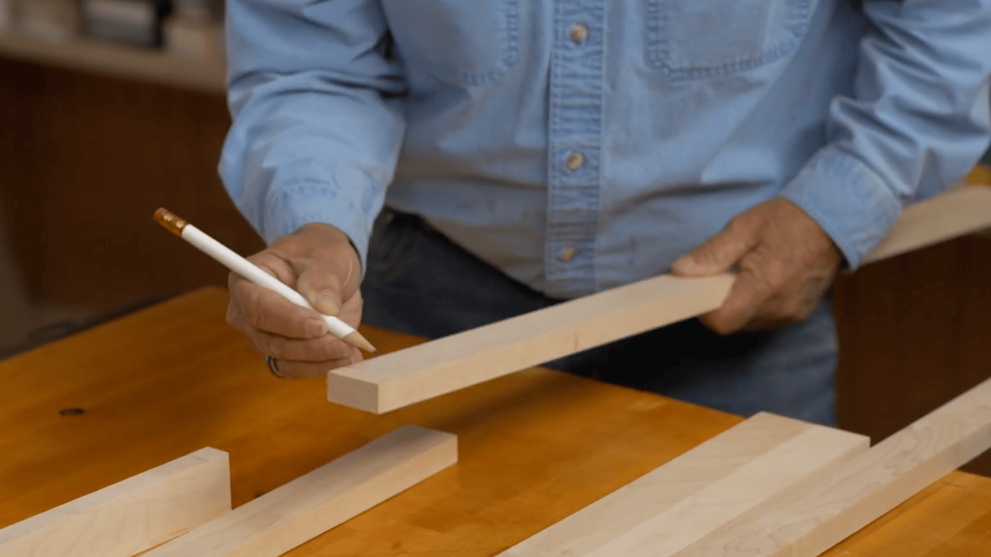 marking wood pieces and assembling shelf parts for diy clothes rack using pencil and measured joints