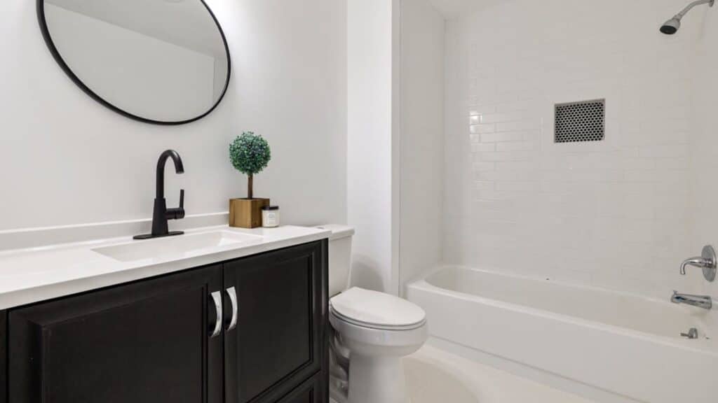 modern bathroom with mixed metals in bathroom design matte black faucet and chrome fixtures creating balanced look