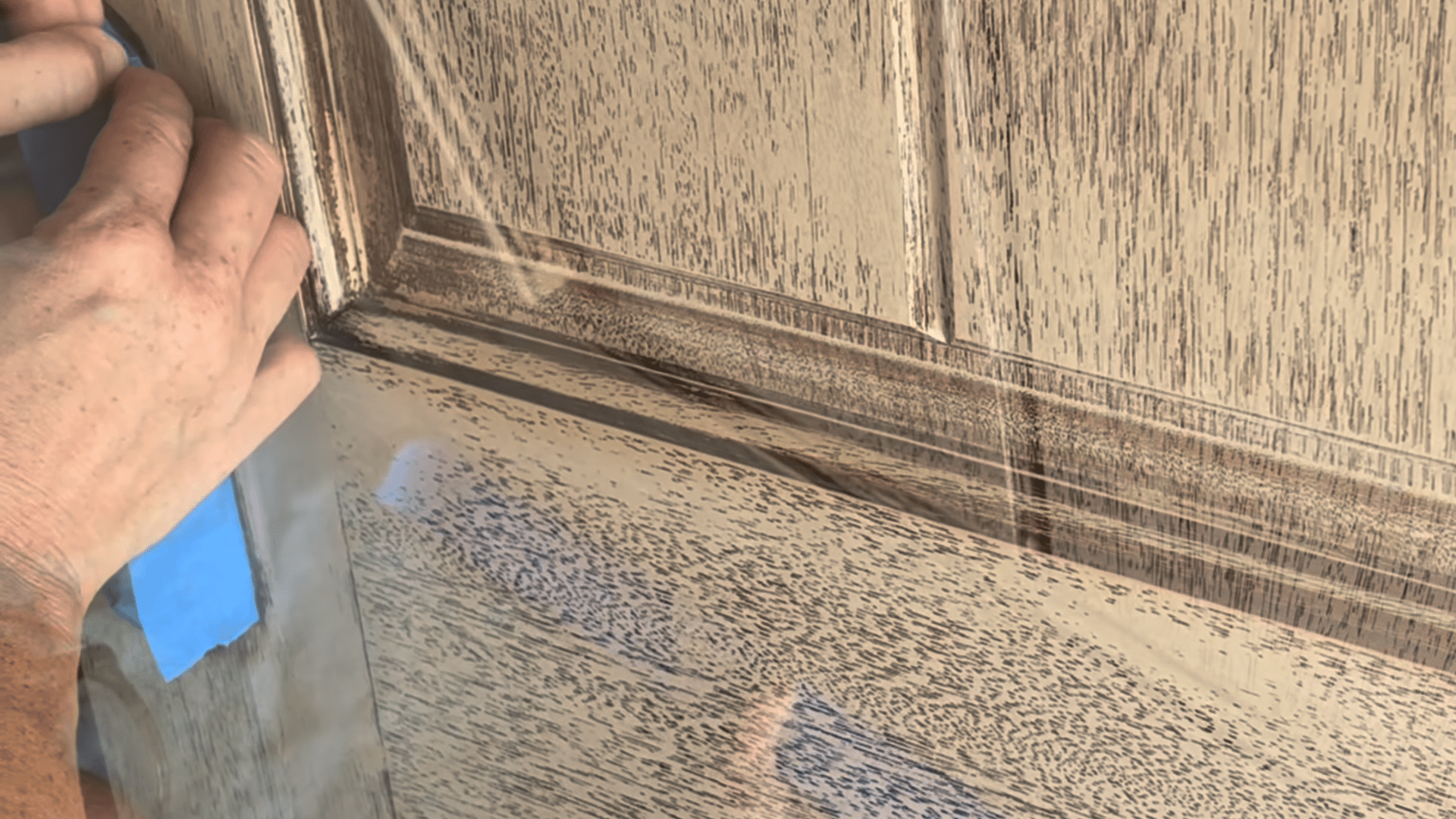 painting front door black preparation applying tape and plastic to protect door trim before painting front door black