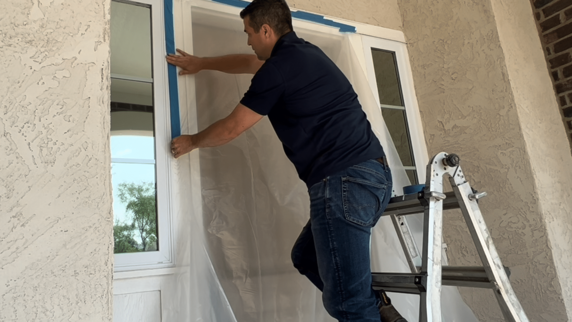 painting front door black preparation covering entryway with plastic and tape to protect trim before painting front door