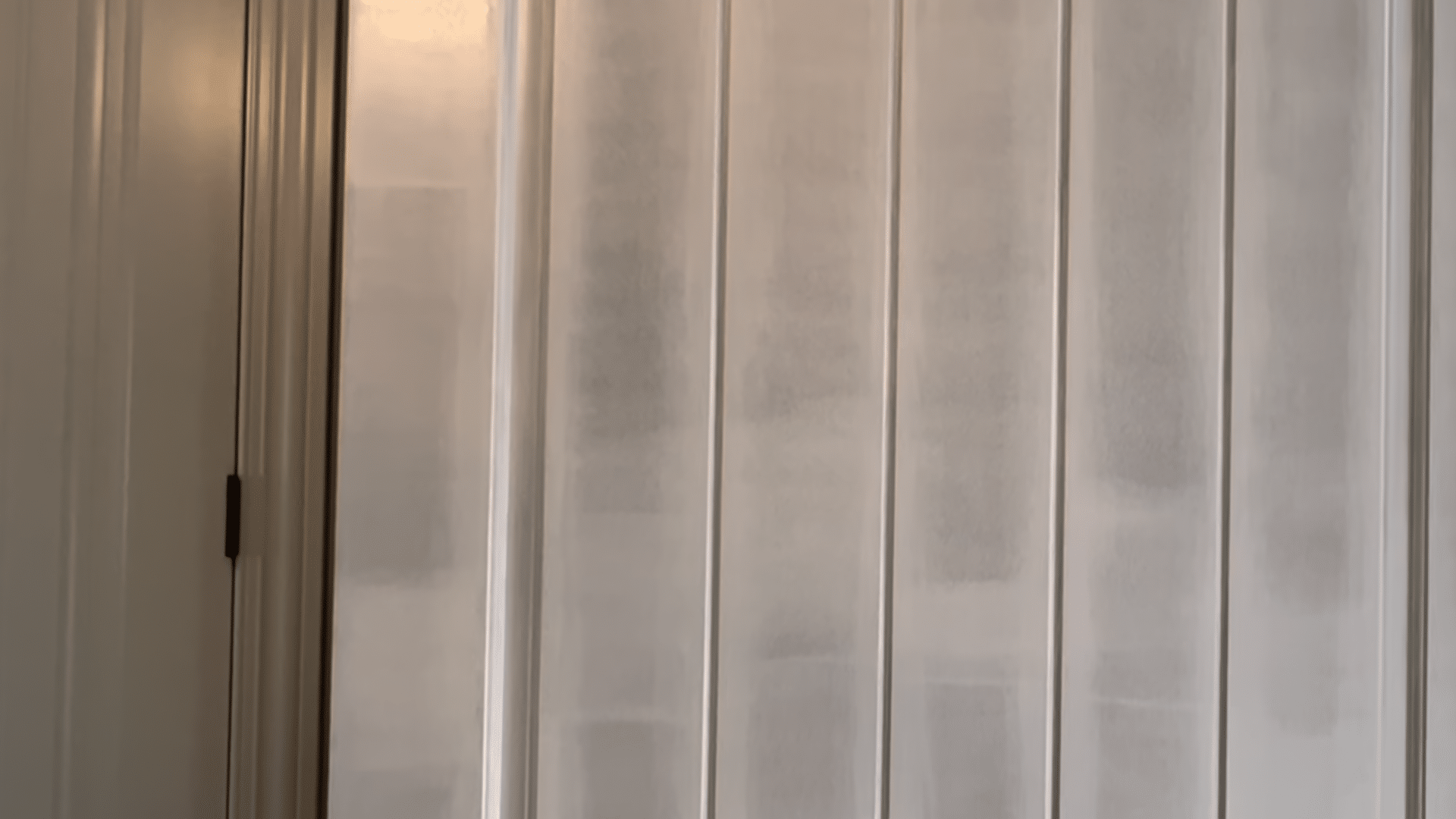 painting front door black showing freshly primed door with smooth surface ready for black paint