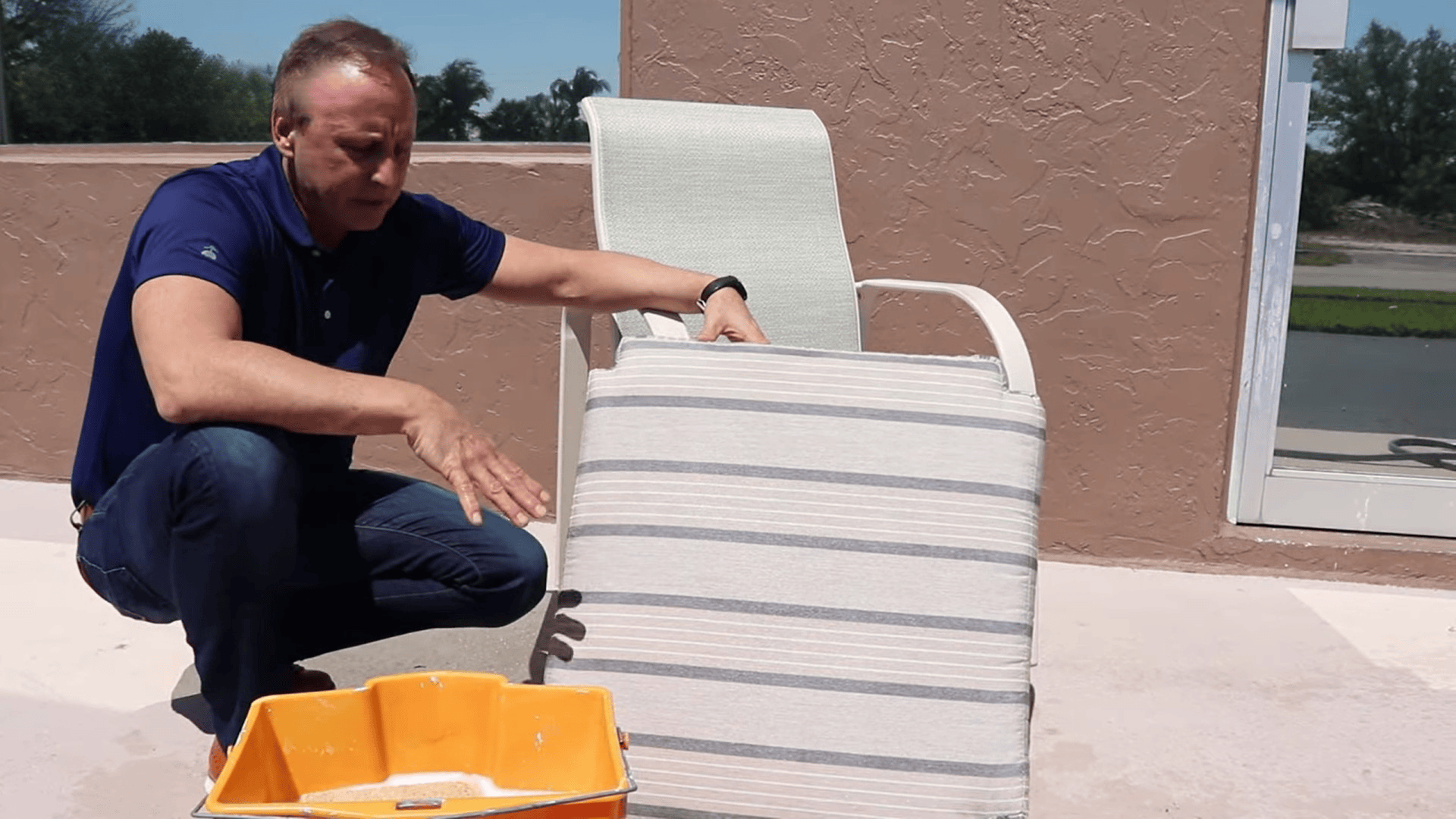 person adjusting and placing cleaned outdoor cushion back on chair showing how to clean sunbrella cushions after washing and drying (3)