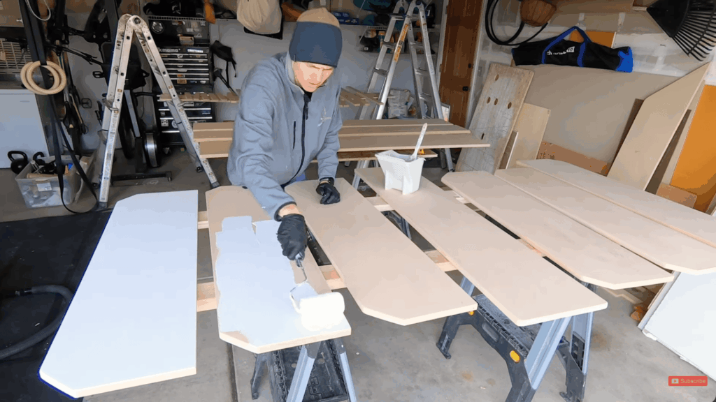 sanding mdf shelves with sandpaper before painting to ensure smooth edges and surface