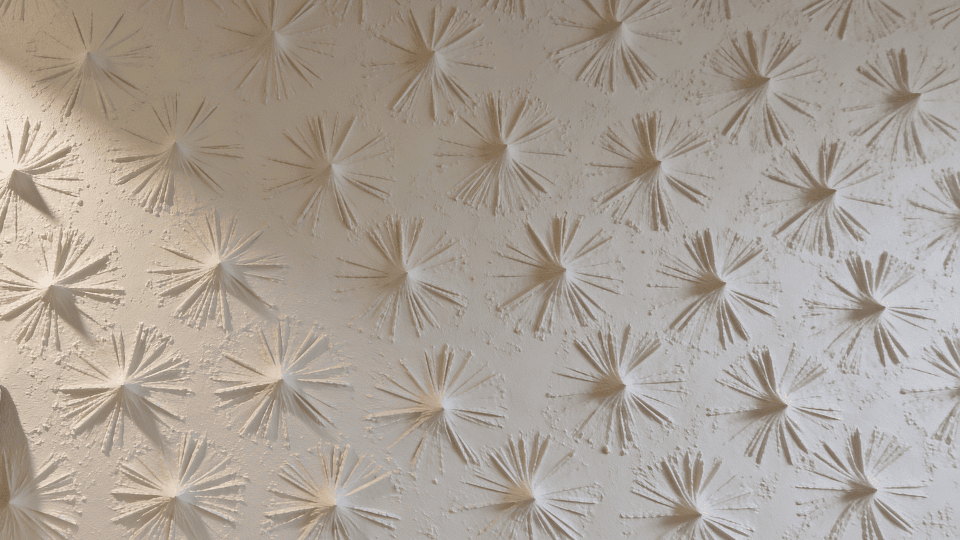 textured wall with raised starburst patterns under ceiling light in room