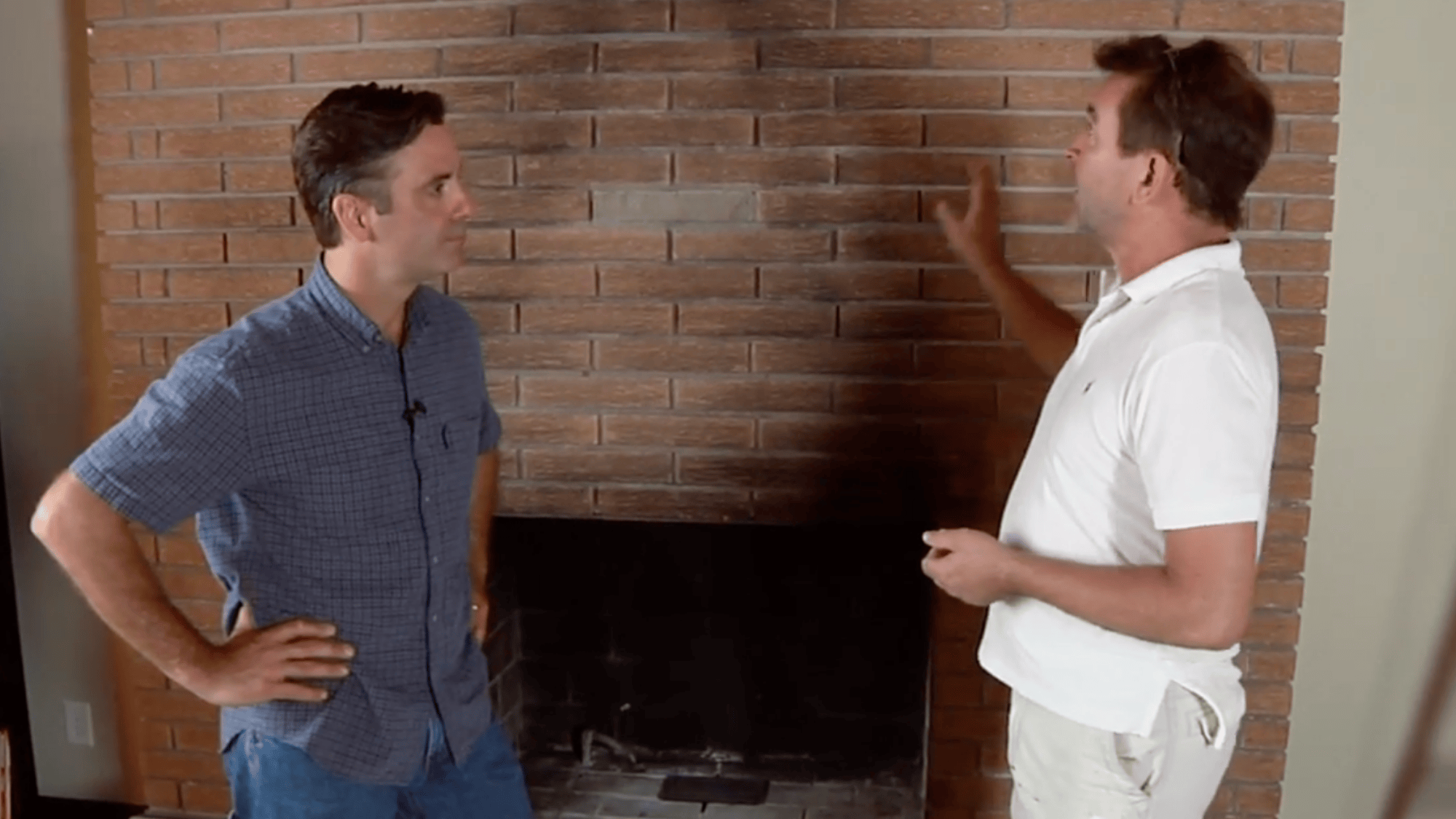 two men checking brick fireplace surface before cleaning properly