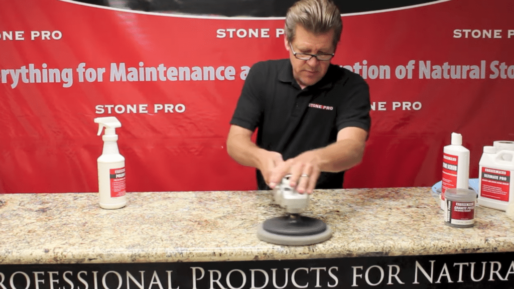 using a low speed polisher to buff granite surface in how to polish granite countertops for a smooth glossy finish