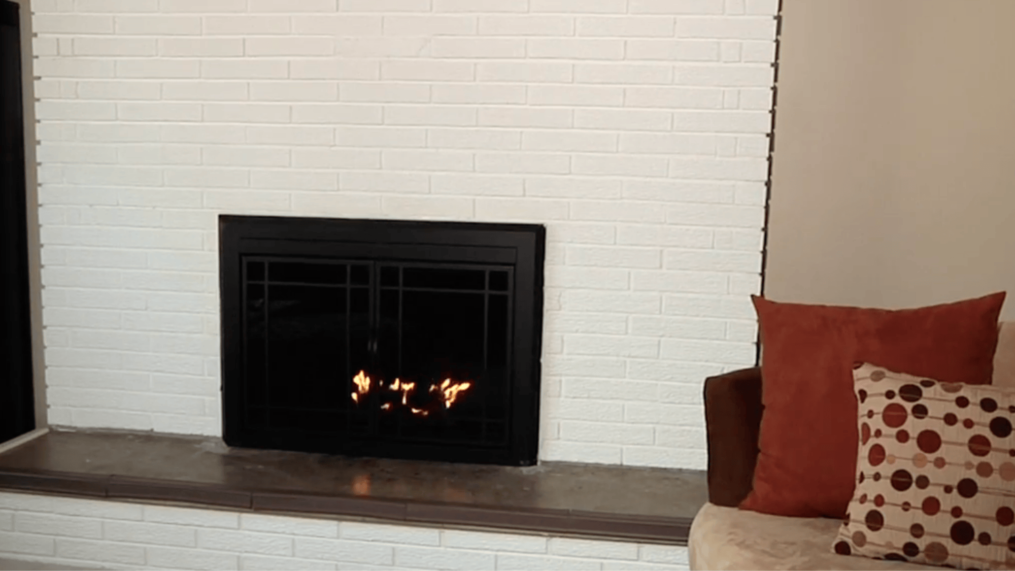 white painted brick fireplace showing final result and transformation