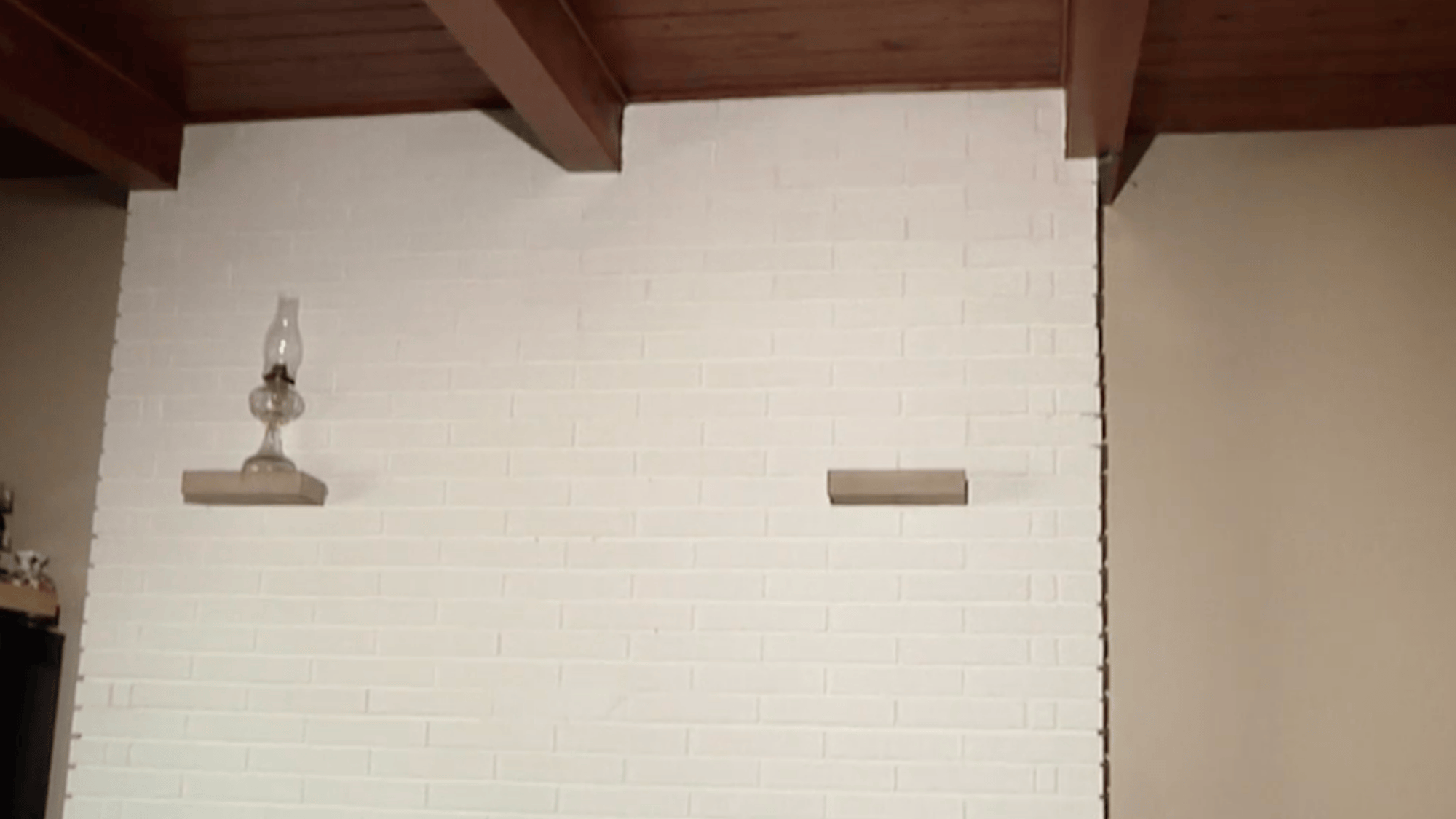 white painted brick fireplace wall showing final paint coat applied