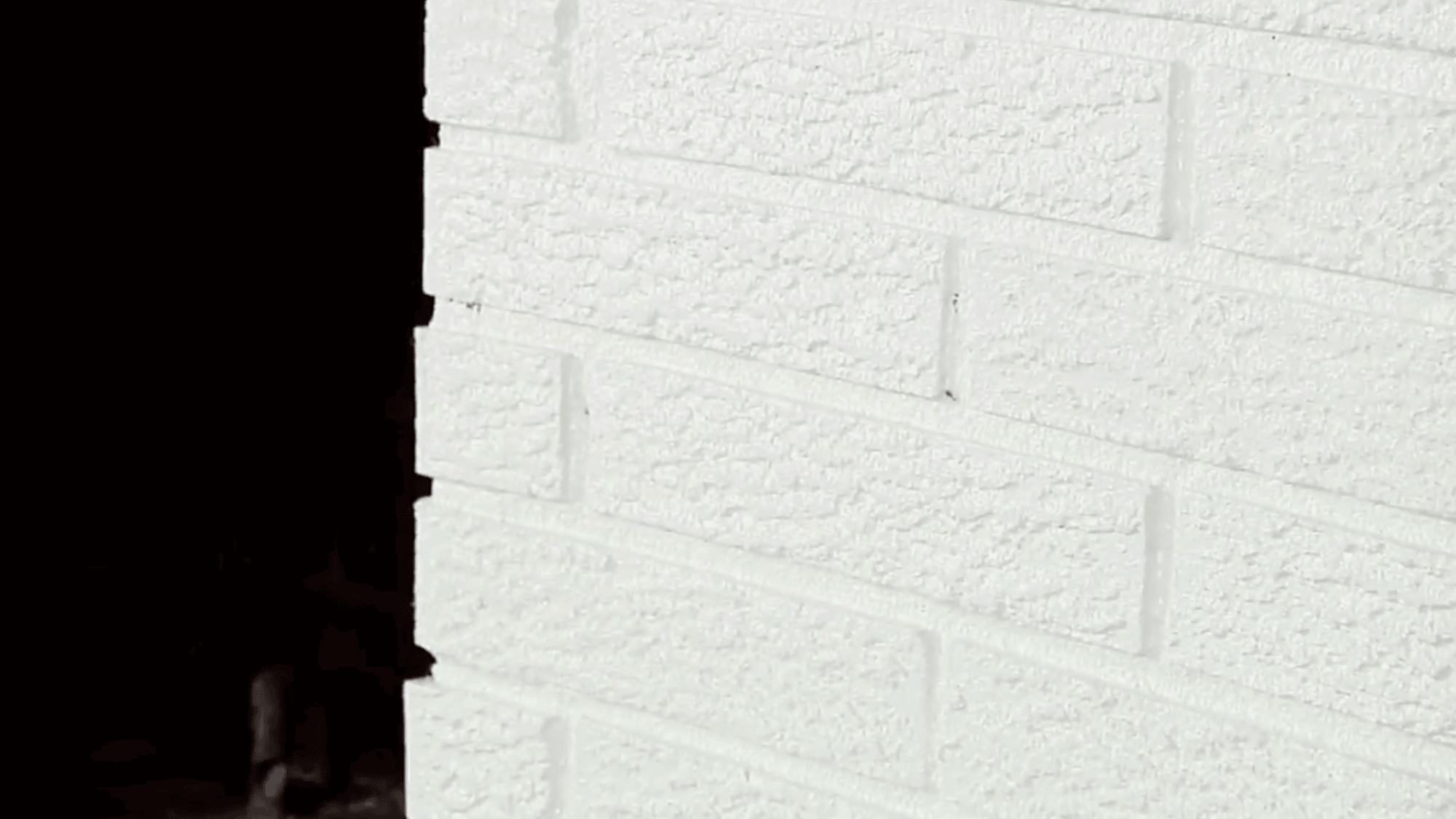 white primed brick wall left to dry before painting