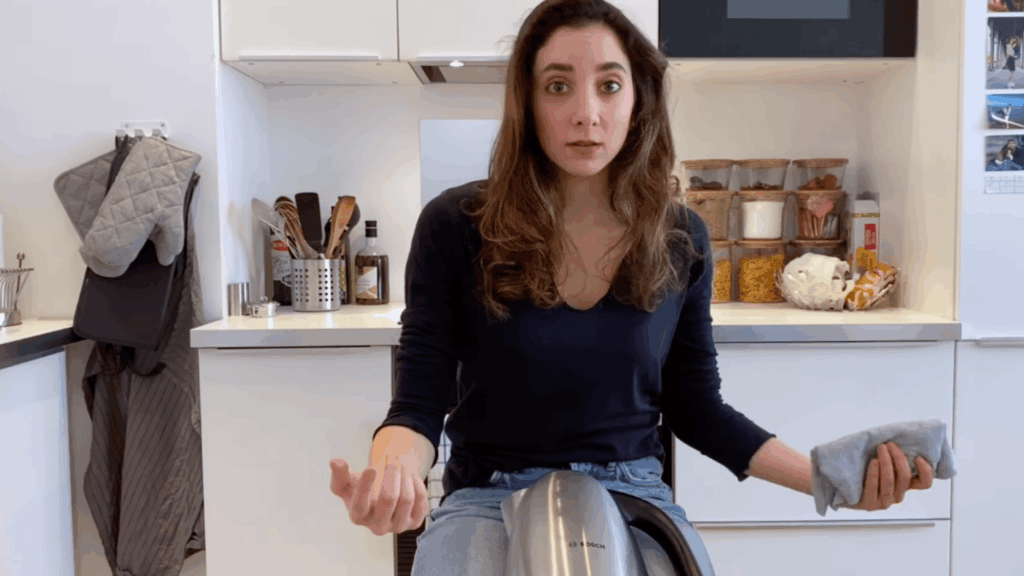 wiping electric kettle outside with cloth to clean surface safely without using water or damage