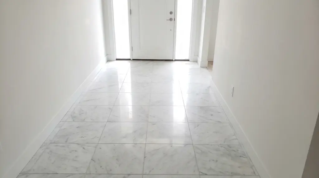 Natural white marble floor tiles with soft gray veining in a luxury home entrance with high ceilings