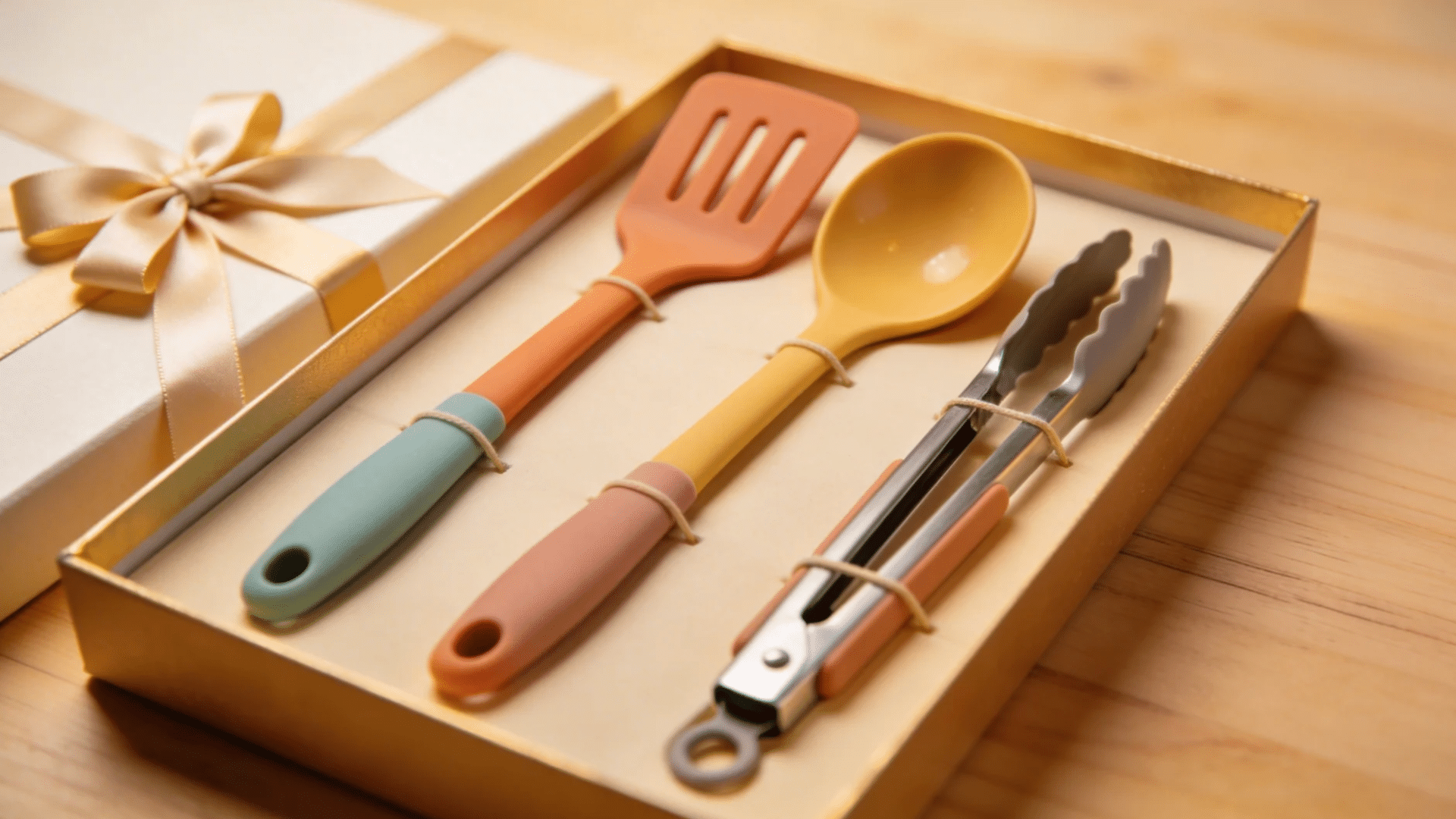 a boxed set of colorful kitchen utensils including a spatula spoon and tongs arranged neatly as a gift for favorite things party gift ideas