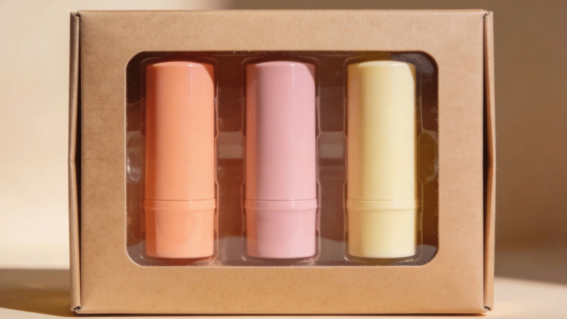 a set of pastel colored lip balm sticks neatly arranged in a box for favorite things party gift ideas