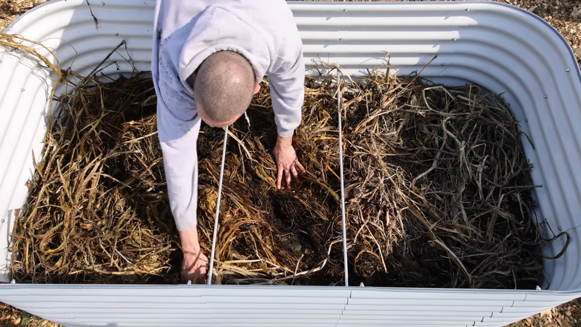 adding dry organic matter layer showing how to layer a raised garden bed for nutrient balance and soil structure