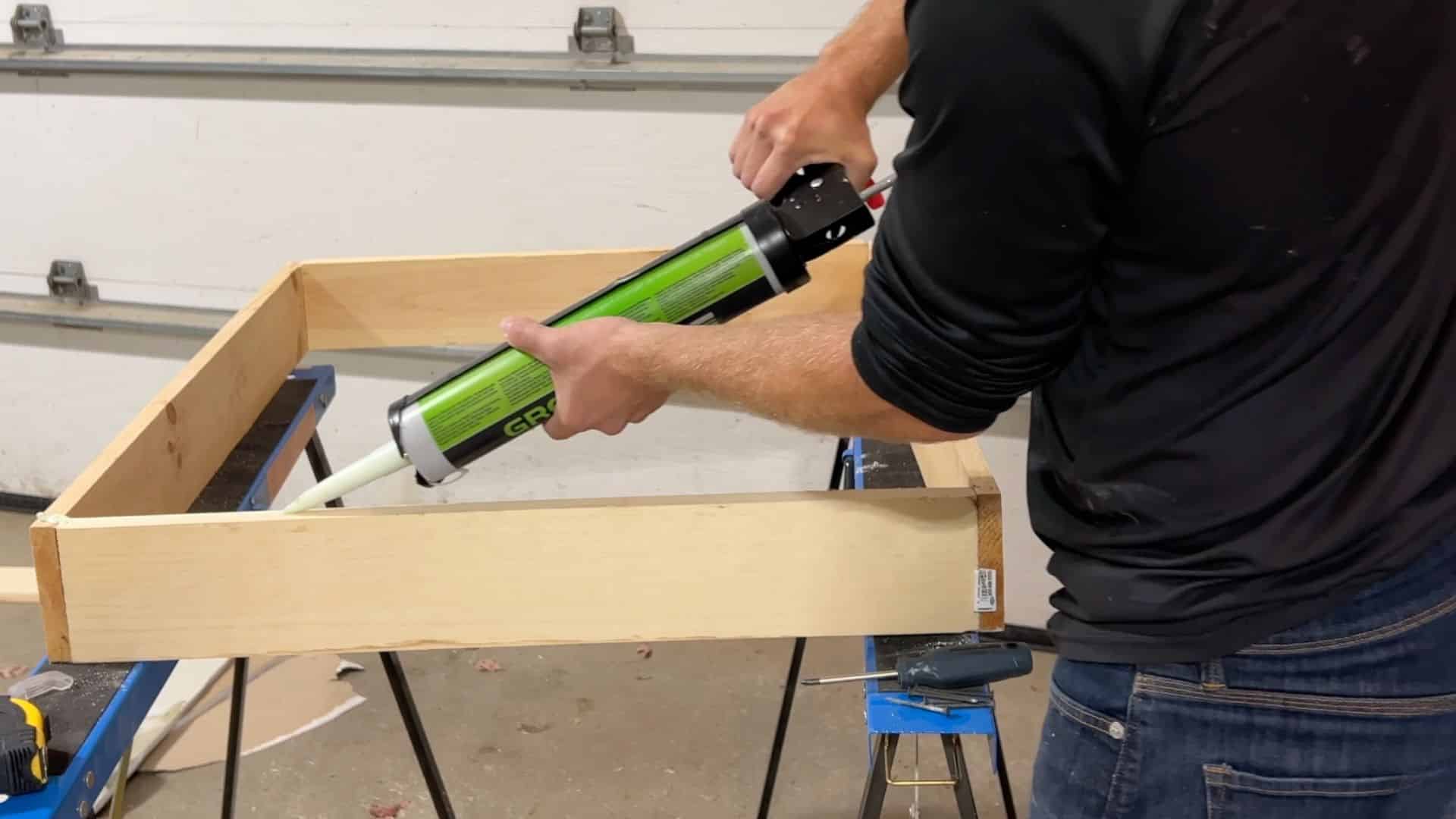 applying acoustic sealant along frame edges to block sound leaks and gaps