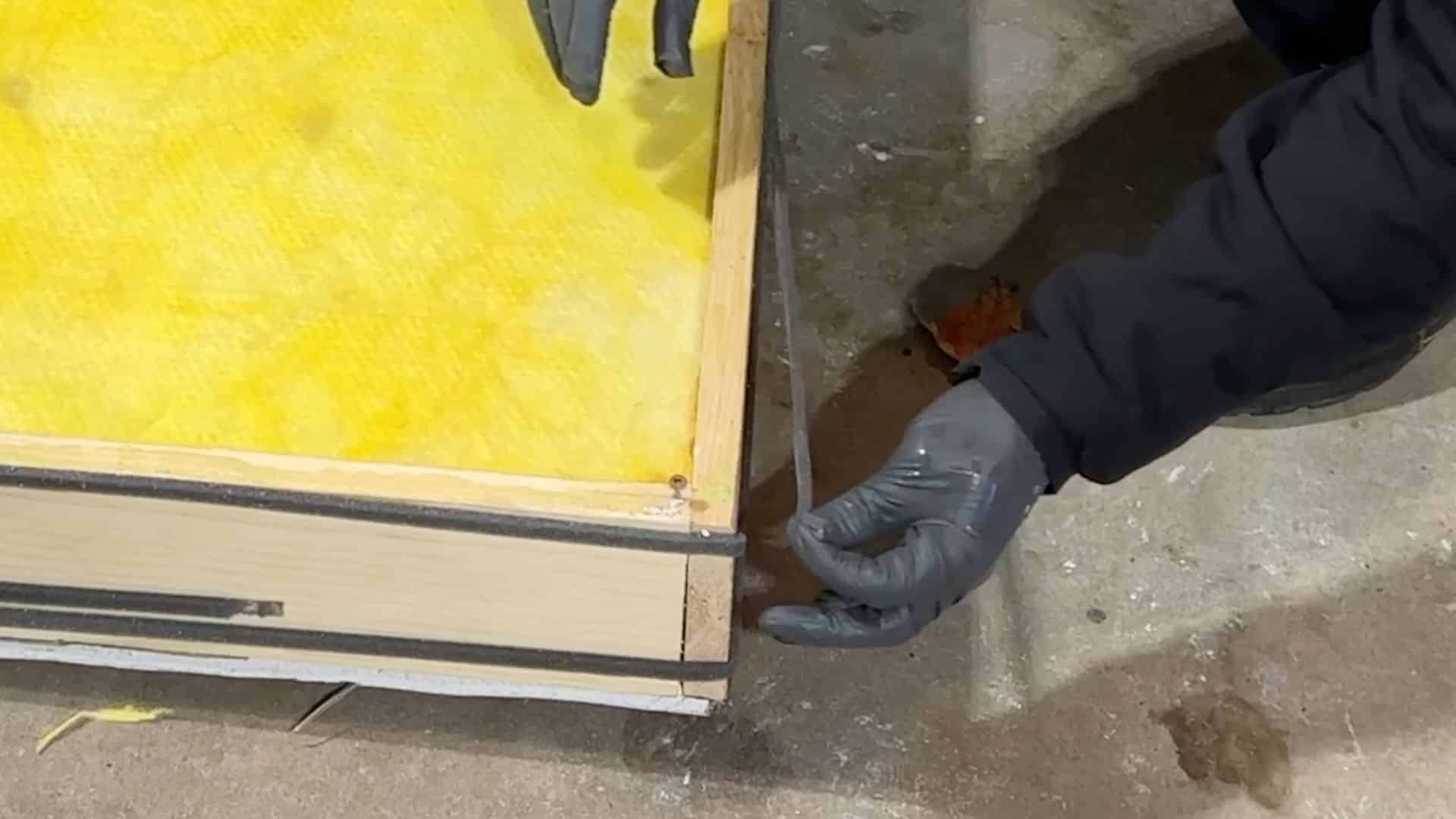 applying weather stripping around edges to create tight seal and reduce outside noise