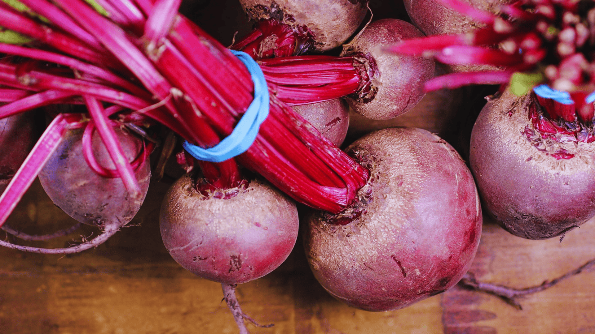 bunch of fresh beets with vibrant red stems tied together