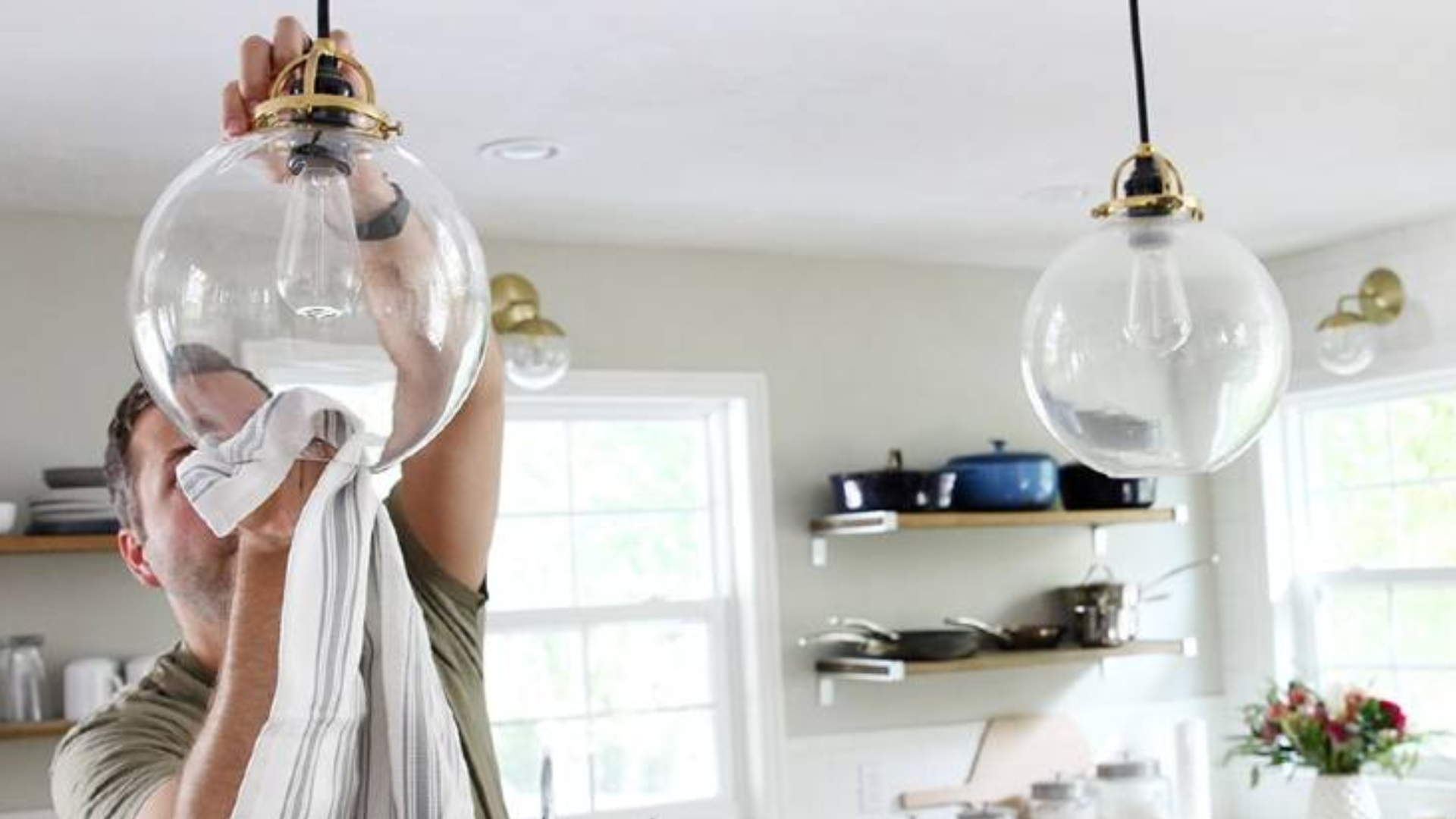 cleaning ceiling light fixture during monthly house cleaning routine