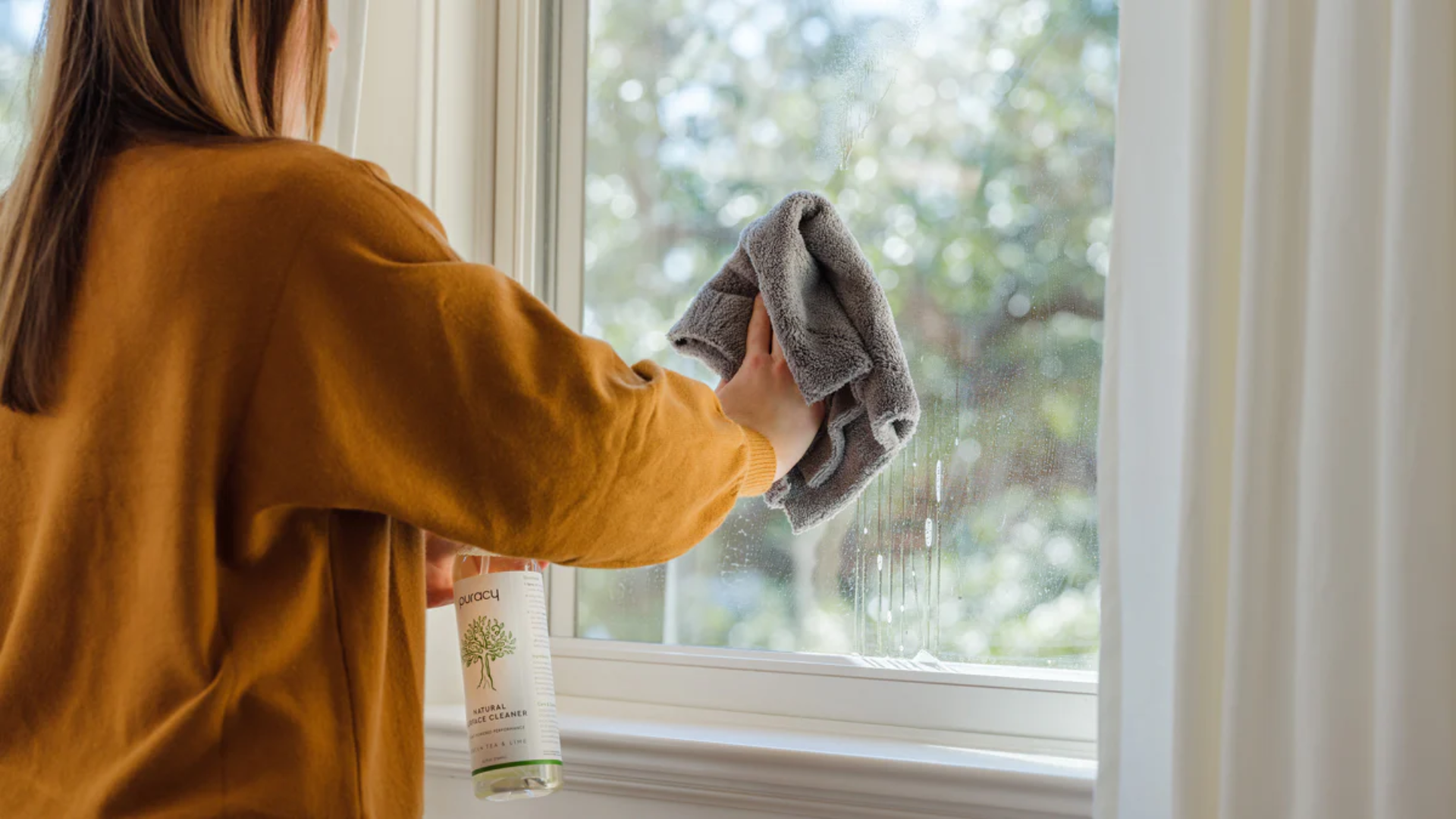 cleaning window glass during seasonal house cleaning routine