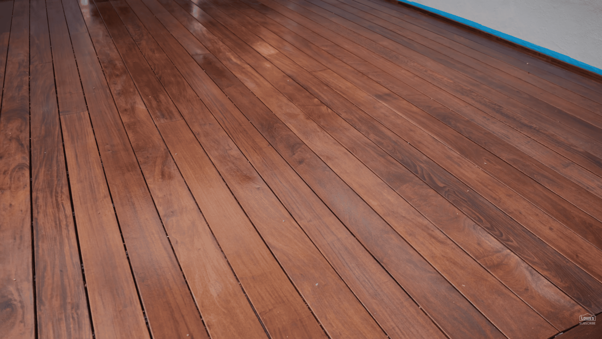 close view of freshly stained wooden deck boards with rich brown finish and smooth polished appearance