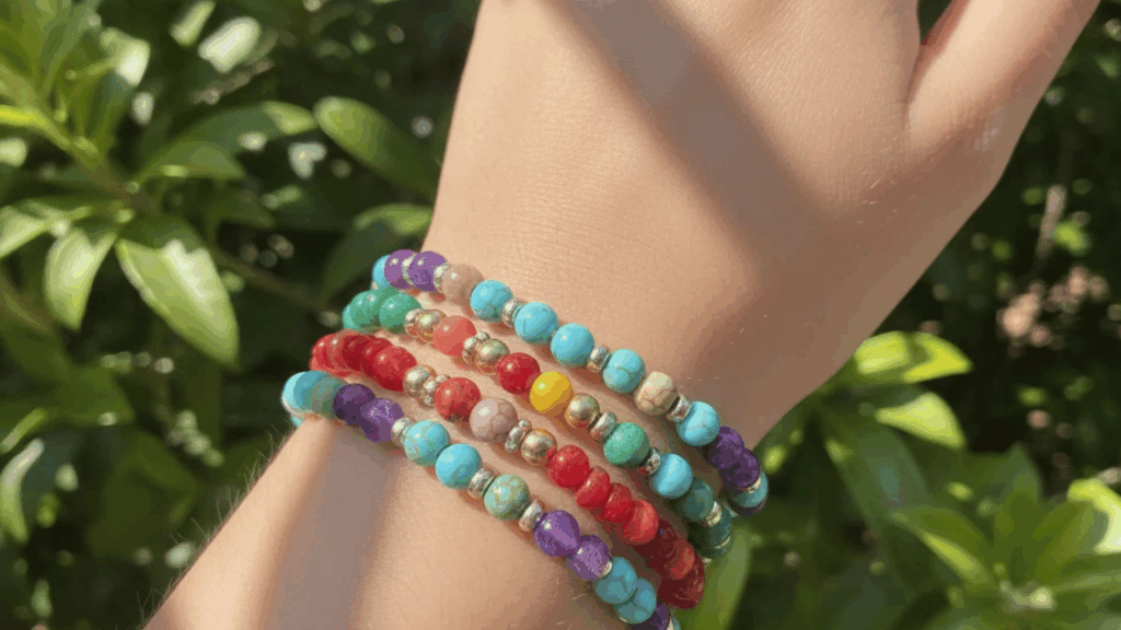 colorful beaded bracelets on wrist outdoors with green leaves background