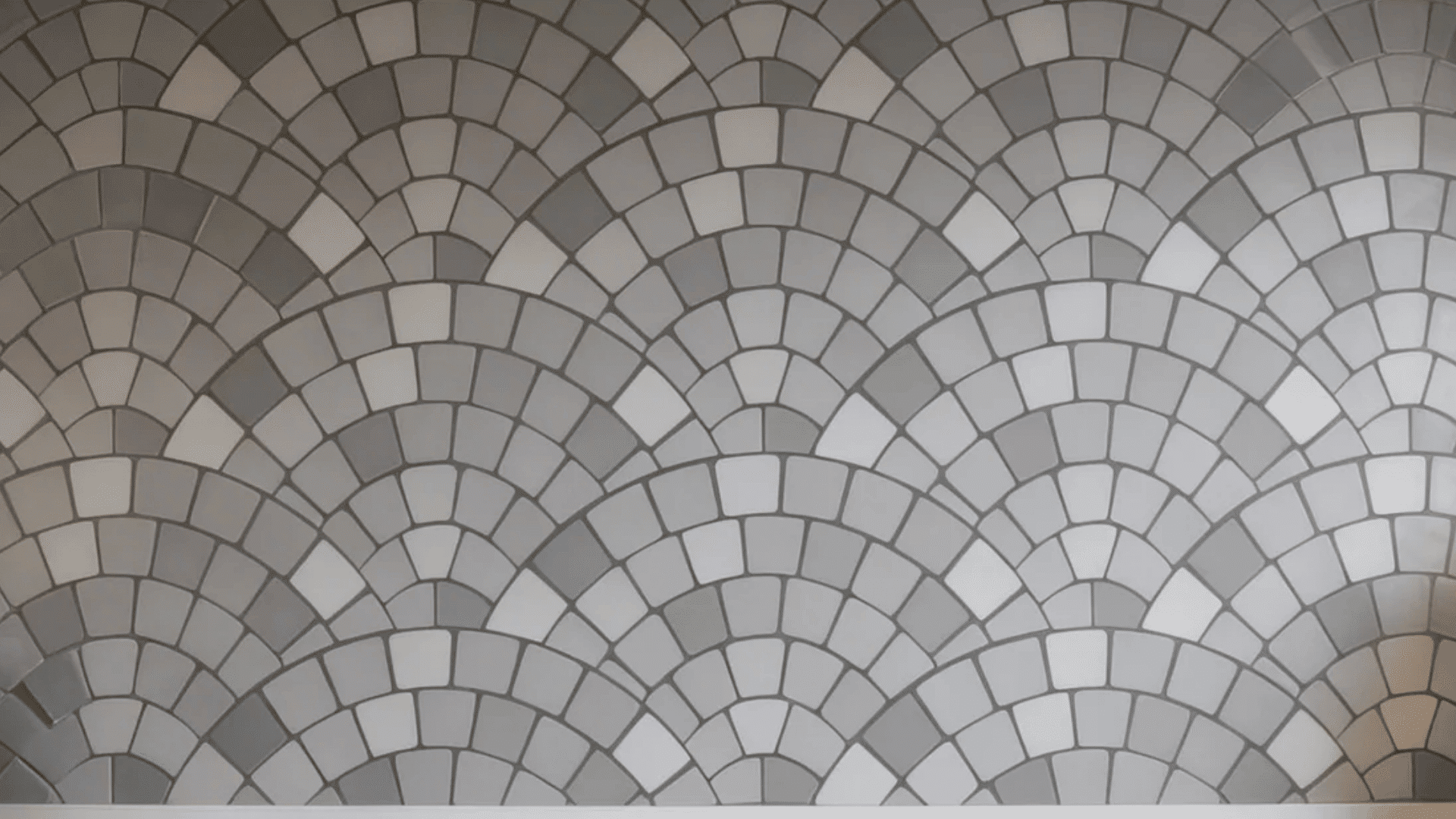 fan tile pattern with curved shell shaped tiles arranged to create soft flowing wall design