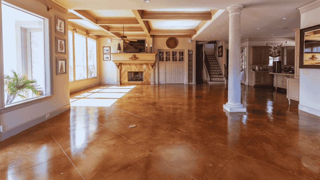 Farmhouse Stained Concrete Floors: Ideas and Design Tips farmhouse stained concrete floors in open living space with warm brown finish and rustic interior design