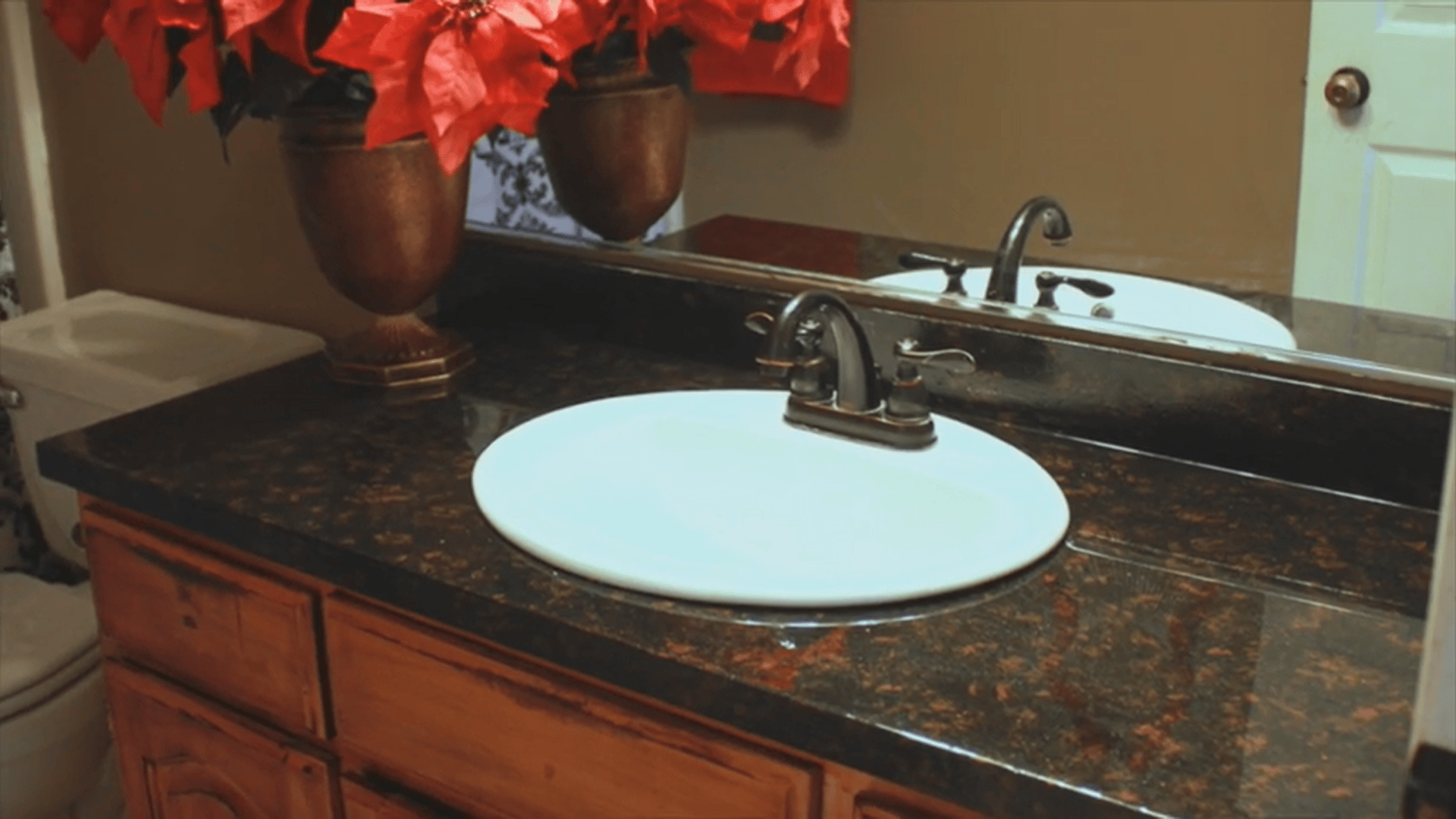 Finished bathroom vanity with glossy surface after resurfacing laminate countertops process