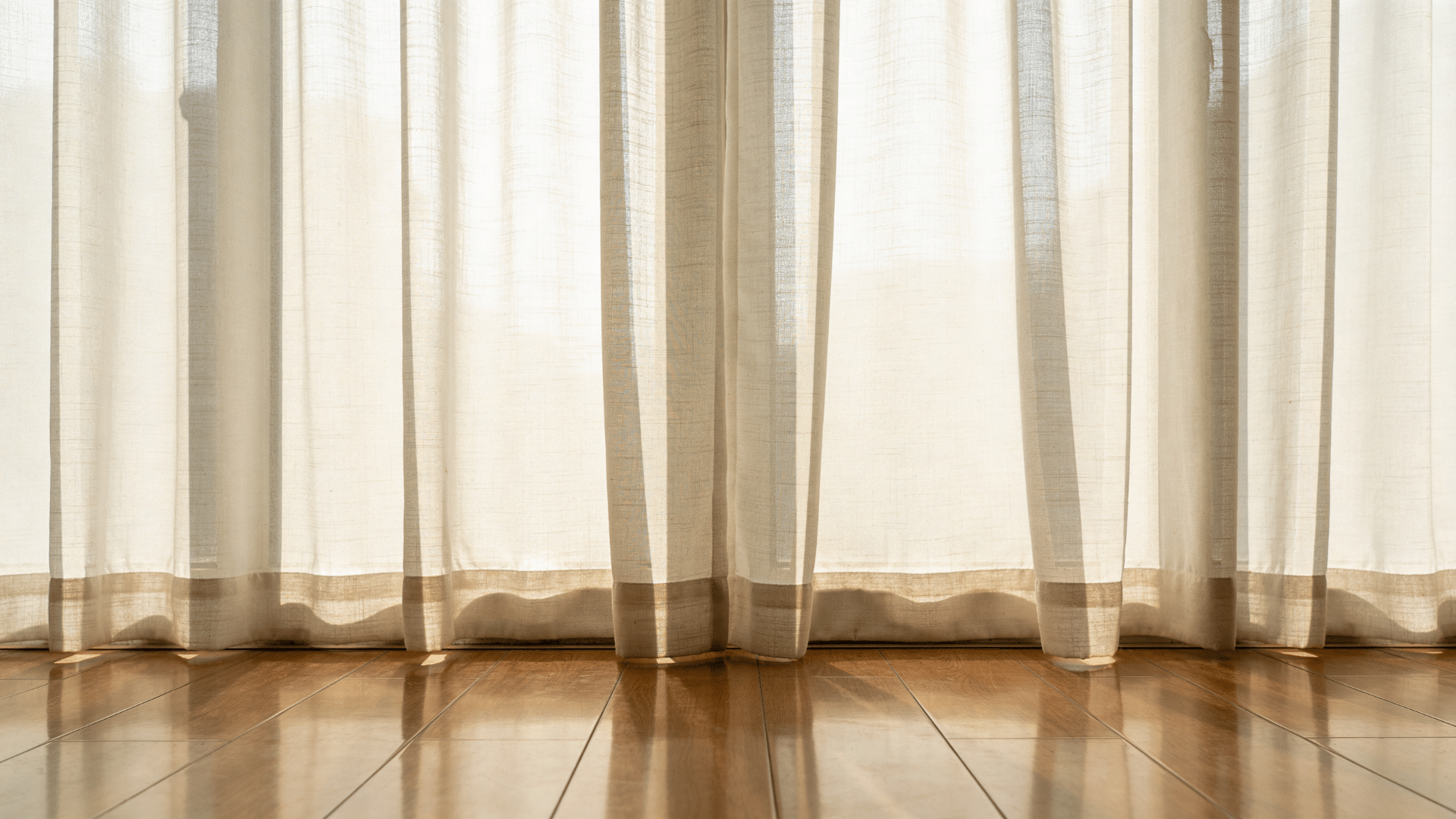 floor length sheer curtains softly touching wooden floor