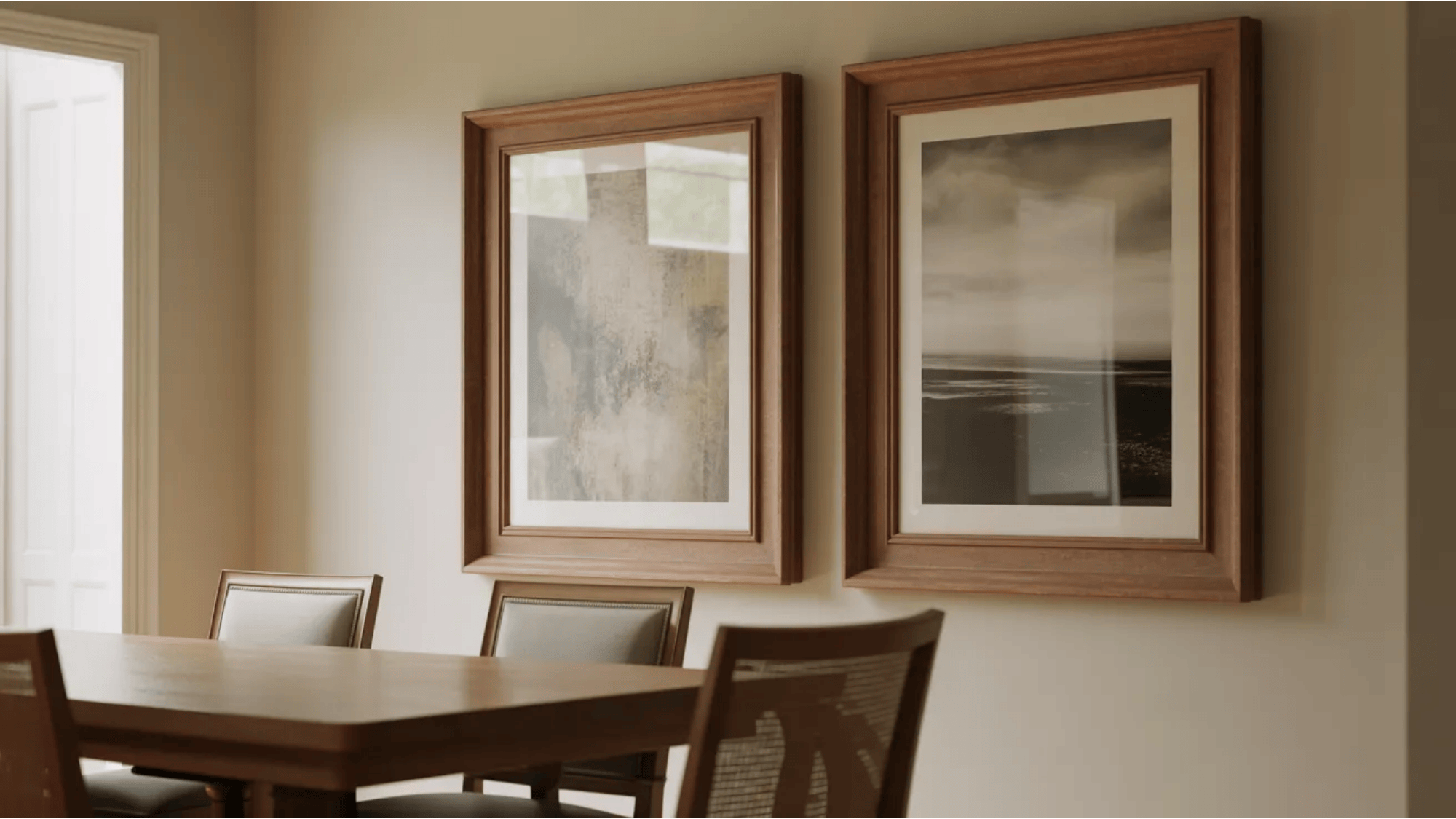 framed artwork above wooden dining table creating a warm gallery wall in a calm transitional dining room