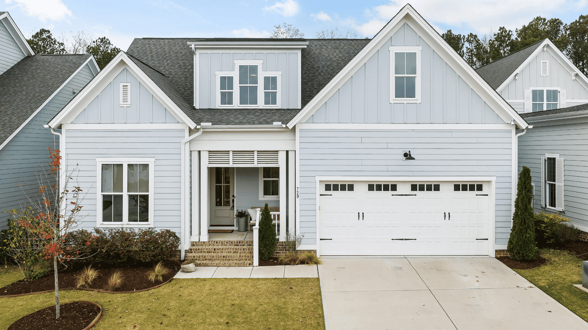 front view of a modern home with garage and driveway representing a property involved in an earnest money home purchase agreement