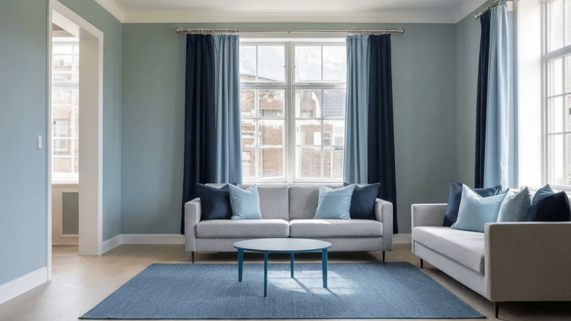 gray living room with blue curtains blue rug and gray sofa modern interior design