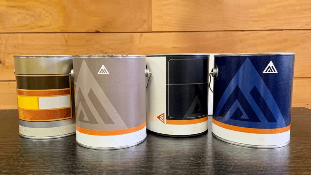 group of interior trim paint cans on table showing different finishes as best paint for trim in workshop setting